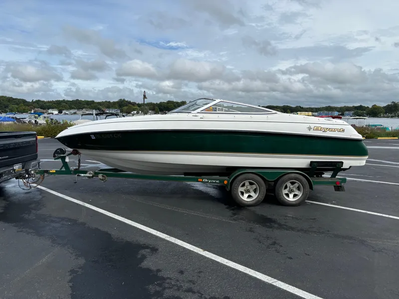 Slide: The Image of 2002 Bryant 214 boat on trailer in parking lot, cloudy sky background. - 9