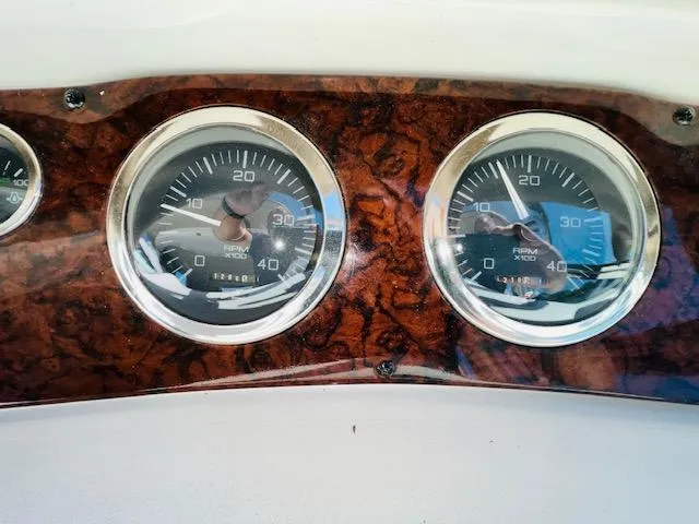 Slide: The Image of Dashboard gauges of a 1999 Sea Ray 460 Sundancer boat. - 12