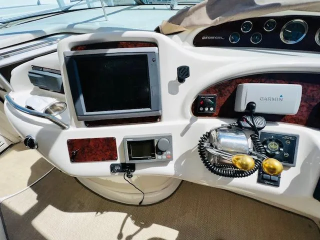 Slide: The Image of 1999 Sea Ray 460 Sundancer helm with navigation equipment and controls. - 13