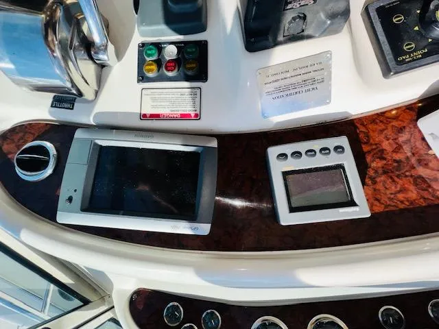 Slide: The Image of Control panel of a 1999 Sea Ray 460 Sundancer yacht with navigation instruments. - 14