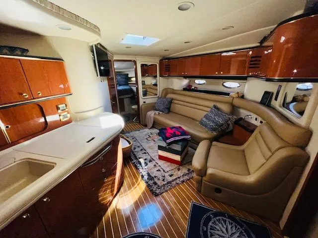 Slide: The Image of Luxurious interior of 1999 Sea Ray 460 Sundancer yacht with leather seating and wood finishes. - 15