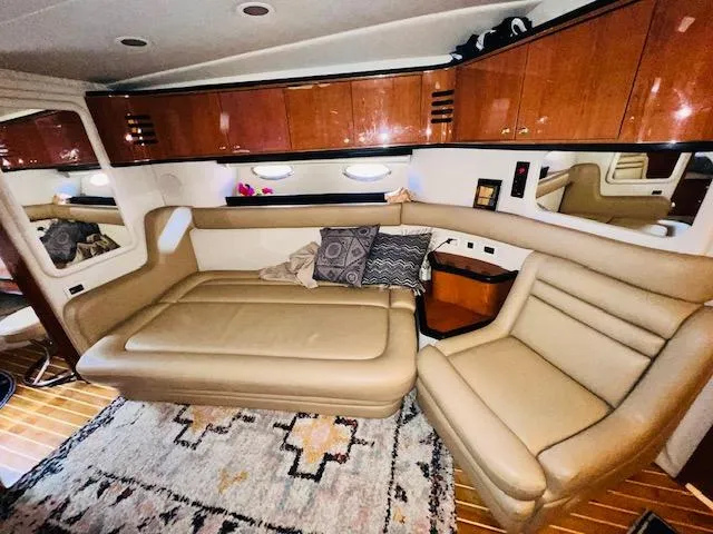 Slide: The Image of Luxurious interior of 1999 Sea Ray 460 Sundancer yacht with leather seating and wooden cabinets. - 19