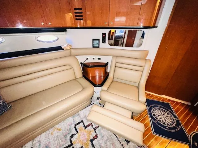 Slide: The Image of Interior of 1999 Sea Ray 460 Sundancer yacht with beige leather seating and wooden cabinetry. - 20