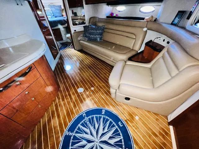 Slide: The Image of Luxurious interior of 1999 Sea Ray 460 Sundancer yacht with leather seating and wooden flooring. - 21