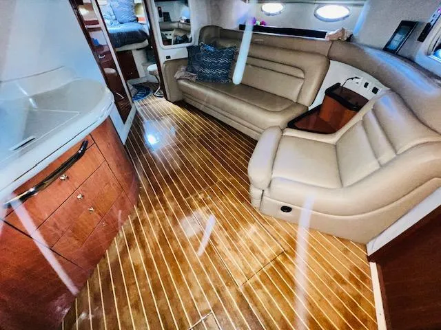 Slide: The Image of Interior of 1999 Sea Ray 460 Sundancer yacht with leather seating and wooden flooring. - 23