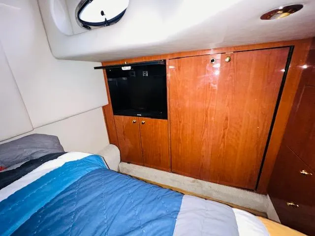 Slide: The Image of Interior cabin of 1999 Sea Ray 460 Sundancer with wood cabinets and bed. - 30