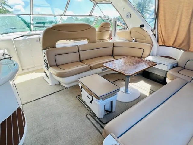 Slide: The Image of Luxurious interior of 1999 Sea Ray 460 Sundancer yacht with beige seating and wooden table. - 7