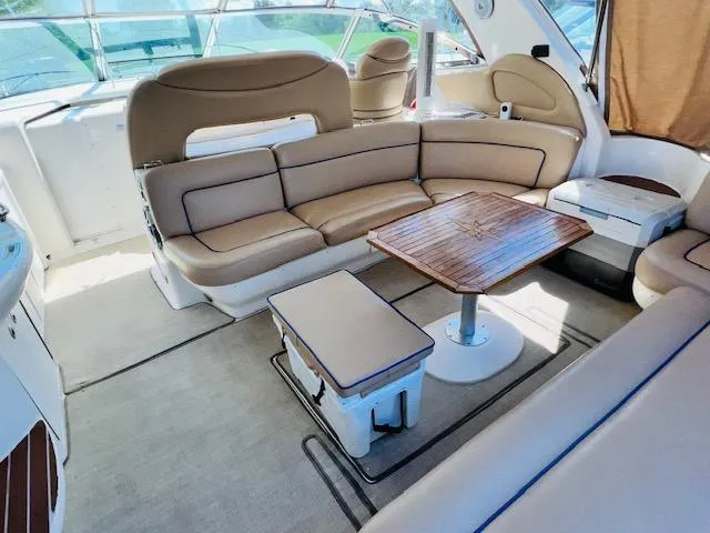 Slide: The Image of Luxurious interior of 1999 Sea Ray 460 Sundancer yacht with plush seating and wooden table. - 8