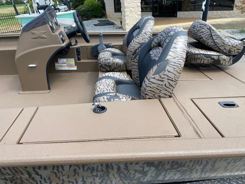 Slide: The Image of 2025 Xpress XP200 boat interior with camo-patterned seats and steering console. - 10