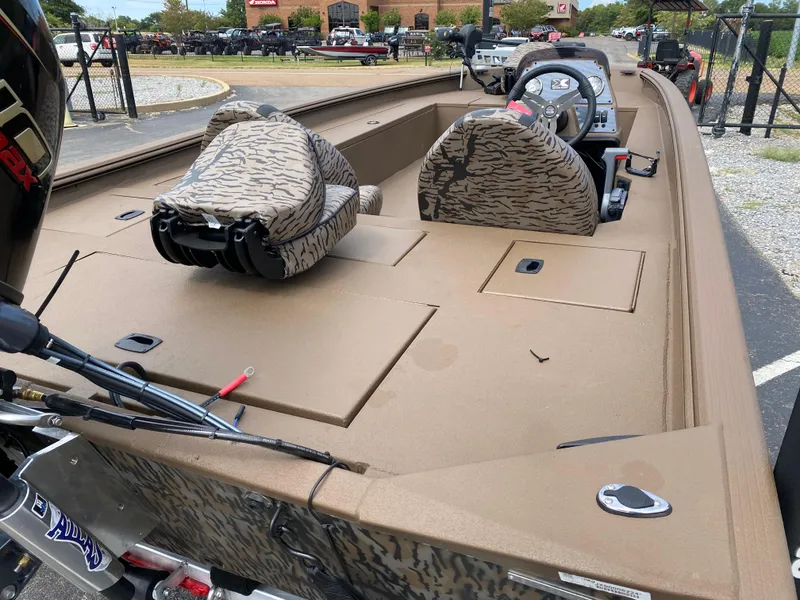Slide: The Image of 2025 Xpress XP200 boat interior with camouflage seats and steering console. - 12