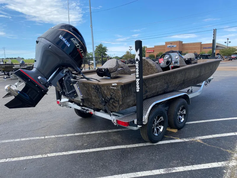 Slide: The Image of 2025 Xpress XP200 boat on trailer with Yamaha outboard motor in parking lot. - 4