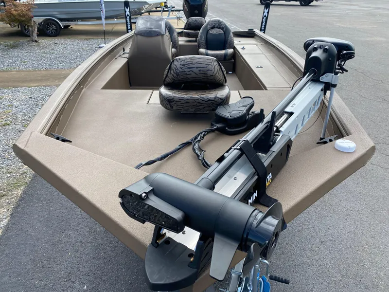 Slide: The Image of 2025 Xpress XP200 boat with trolling motor and seating, parked on pavement. - 7