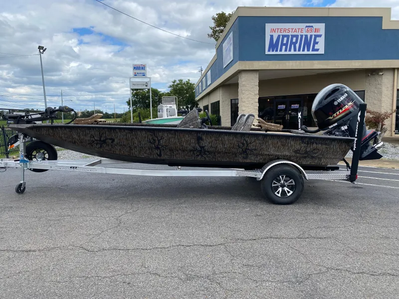 The Image of 2025 Xpress H20C Crappie boat on trailer outside Interstate Marine store. - 0