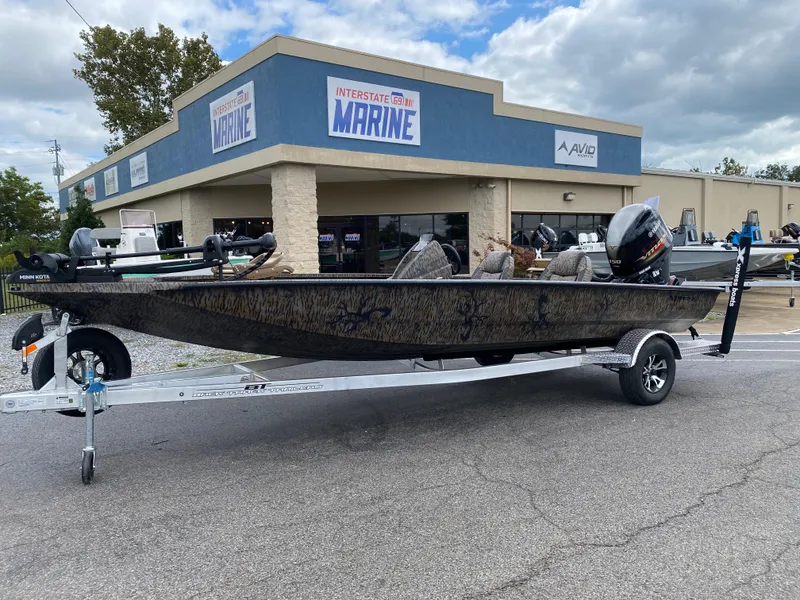 Slide: The Image of 2025 Xpress H20C Crappie boat on trailer outside marine dealership. - 1