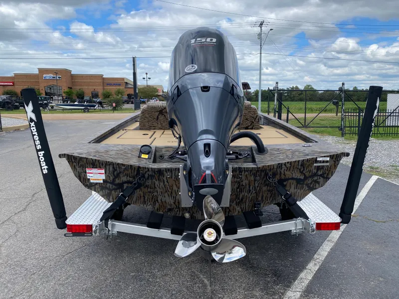 Slide: The Image of 2025 Xpress H20C Crappie boat with powerful outboard motor, parked outdoors. - 3