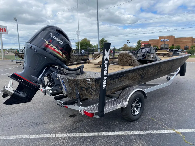 Slide: The Image of 2025 Xpress H20C Crappie boat with Yamaha motor in parking lot. - 4