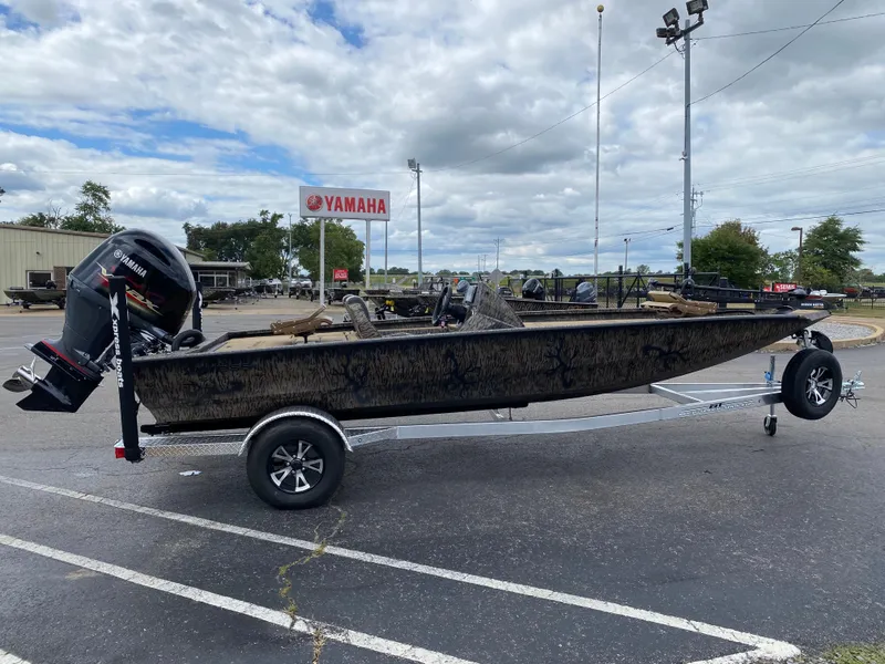Slide: The Image of 2025 Xpress H20C Crappie boat on trailer, parked outdoors near Yamaha sign. - 5