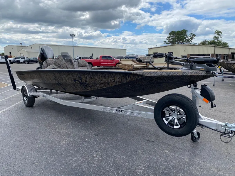 Slide: The Image of 2025 Xpress H20C Crappie boat on trailer, parked outdoors under cloudy sky. - 6