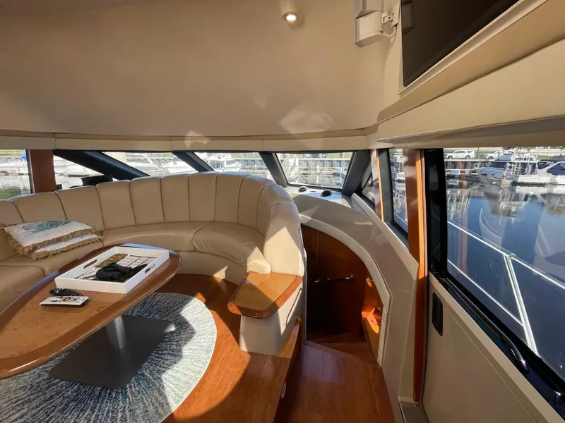 Slide: The Image of Interior of 2006 Carver 56 Voyager yacht with curved seating and wooden table. - 17