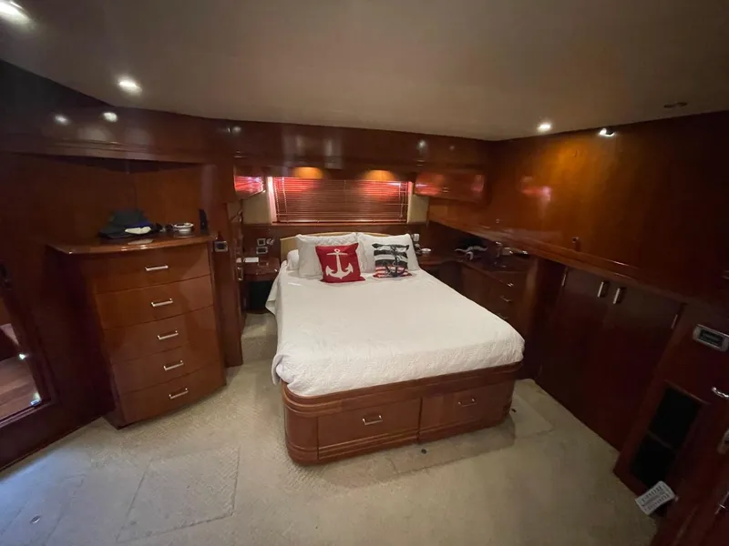 Slide: The Image of Luxurious bedroom in 2006 Carver 56 Voyager yacht with wood paneling and cozy bedding. - 38