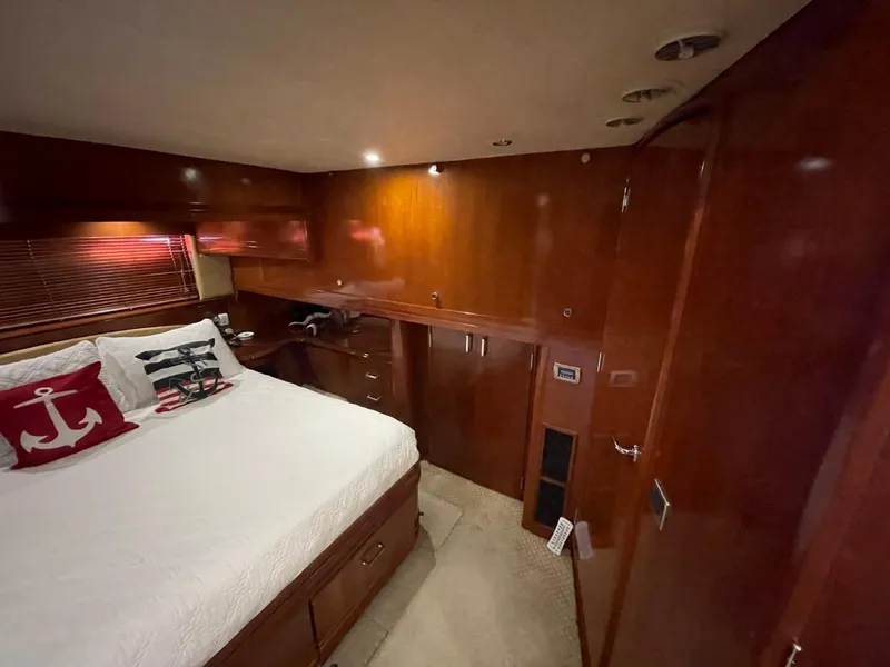 Slide: The Image of Luxurious bedroom interior of 2006 Carver 56 Voyager yacht with wood paneling. - 40