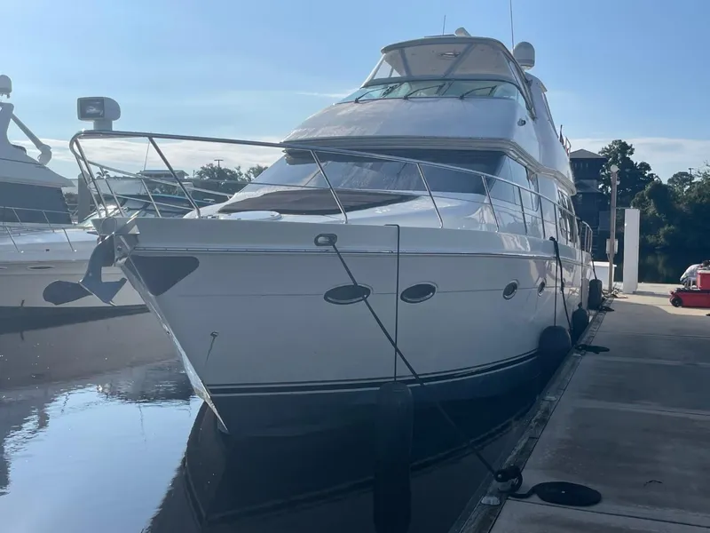 Slide: The Image of 2006 Carver 56 Voyager yacht docked at marina under clear sky. - 5