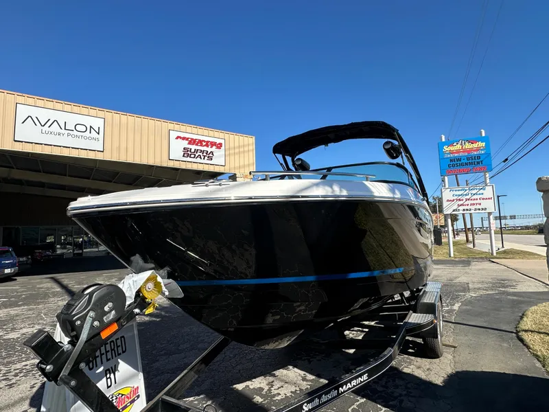 The Image of 2025 Regal LS4 Surf boat on trailer outside dealership. - 0