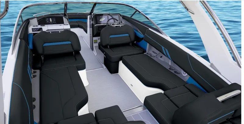 Slide: The Image of 2025 Regal LS4 Surf boat interior with sleek black seating on blue water. - 10
