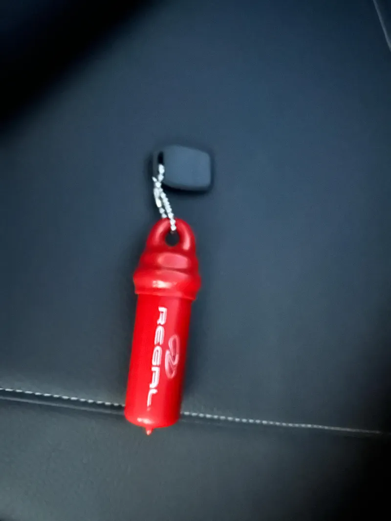 Slide: The Image of Red Regal keychain on black surface, 2025 LS4 Surf model. - 17