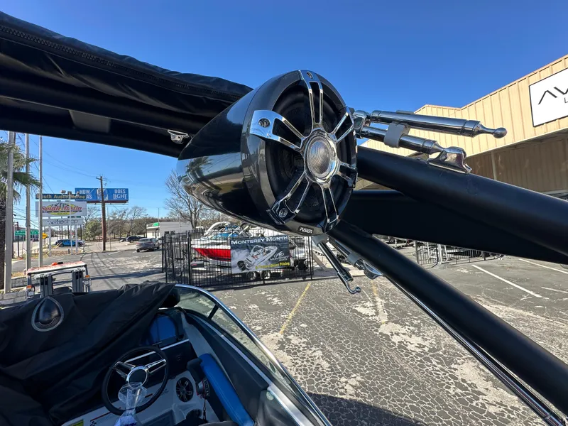 Slide: The Image of 2025 Regal LS4 Surf boat with sleek speaker system and modern design. - 19