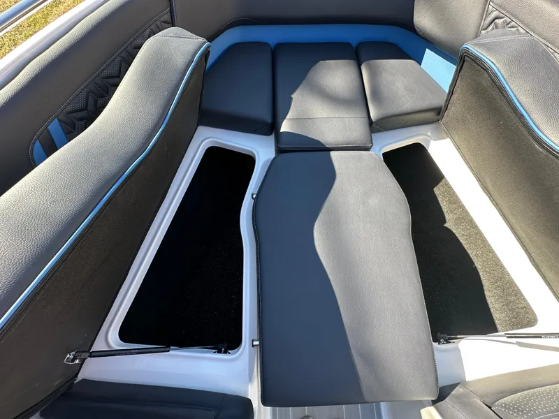 Slide: The Image of 2025 Regal LS4 Surf boat interior with cushioned seating and storage compartments. - 25