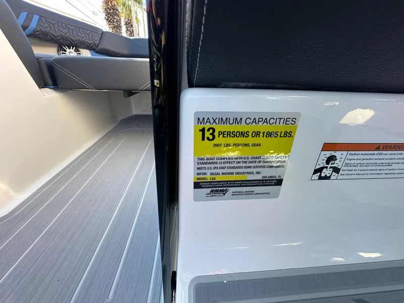 Slide: The Image of 2025 Regal LS4 Surf boat capacity label, maximum 13 persons or 1865 lbs. - 52