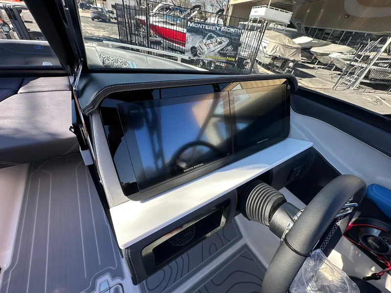 Slide: The Image of 2025 Regal LS4 Surf boat dashboard with modern touchscreen display and steering wheel. - 53