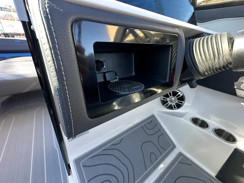 Slide: The Image of 2025 Regal LS4 Surf boat interior with speaker and storage compartment. - 54