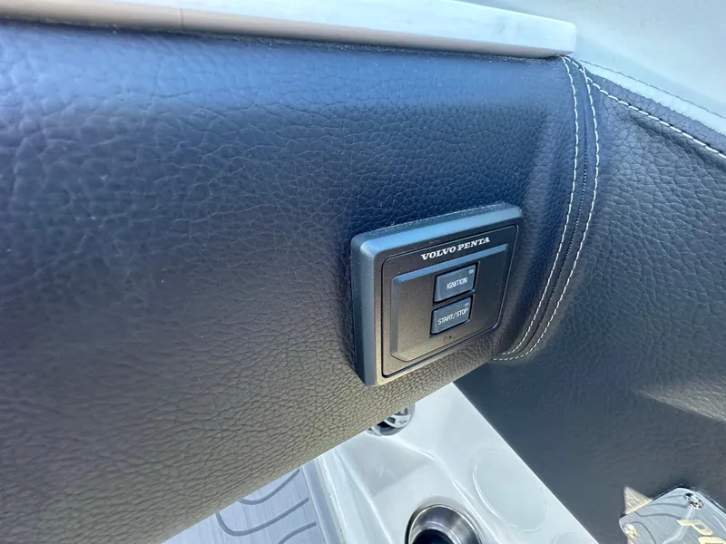 Slide: The Image of 2025 Regal LS4 Surf boat interior with control panel on black leather surface. - 55