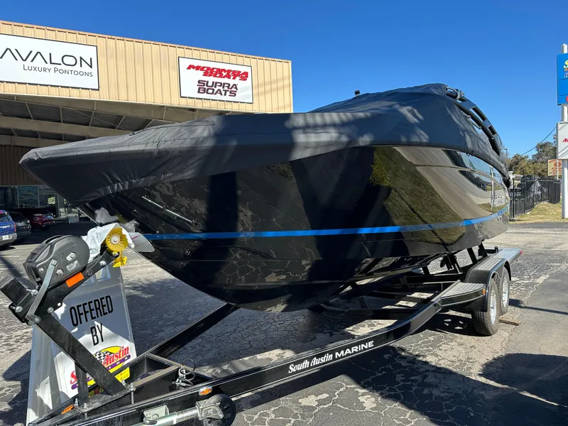 Slide: The Image of 2025 Regal LS4 Surf boat on trailer at South Austin Marine dealership. - 6