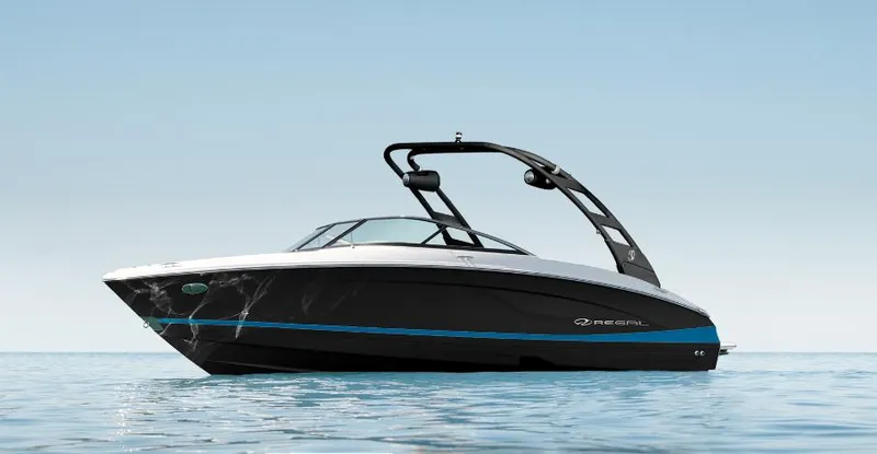 Slide: The Image of 2025 Regal LS4 Surf boat on calm water, sleek black and white design. - 9