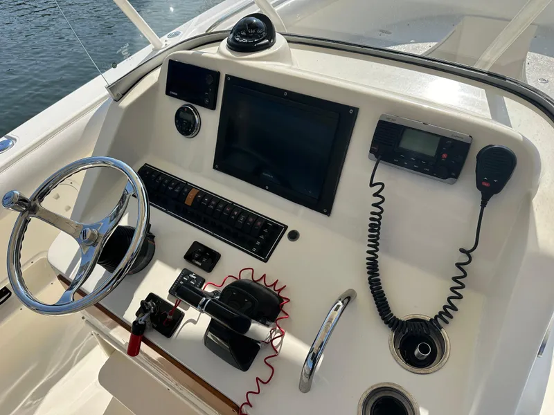 Slide: The Image of Control panel of 2014 Pursuit S 280 Sport boat with steering wheel and navigation equipment. - 10