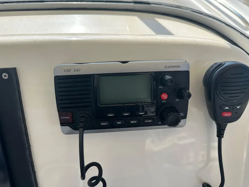 Slide: The Image of VHF radio system on 2014 Pursuit S 280 Sport boat dashboard. - 14