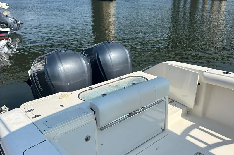 Slide: The Image of 2014 Pursuit S 280 Sport boat with dual outboard motors on calm water. - 18