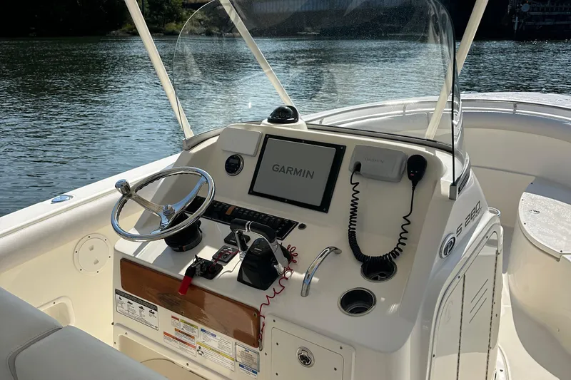 Slide: The Image of 2014 Pursuit S 280 Sport boat dashboard with Garmin navigation system on a sunny day. - 19