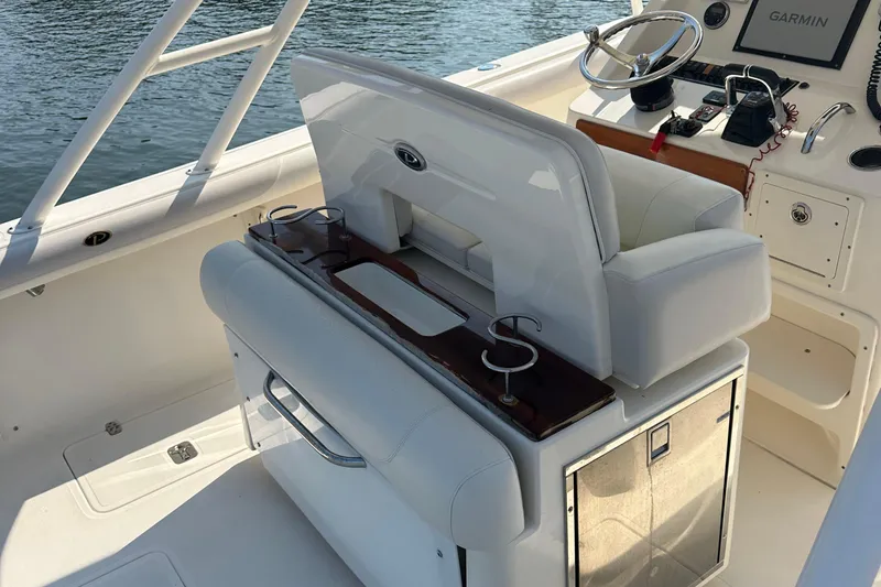 Slide: The Image of 2014 Pursuit S 280 Sport boat interior with helm, seating, and storage. - 20