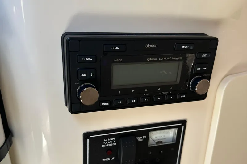 Slide: The Image of Clarion audio system on 2014 Pursuit S 280 Sport boat dashboard. - 21