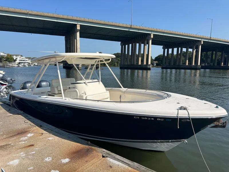 Slide: The Image of 2014 Pursuit S 280 Sport boat docked near a bridge on a sunny day. - 3