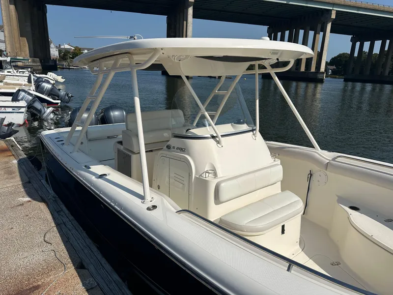 Slide: The Image of 2014 Pursuit S 280 Sport boat docked near a bridge on a sunny day. - 4