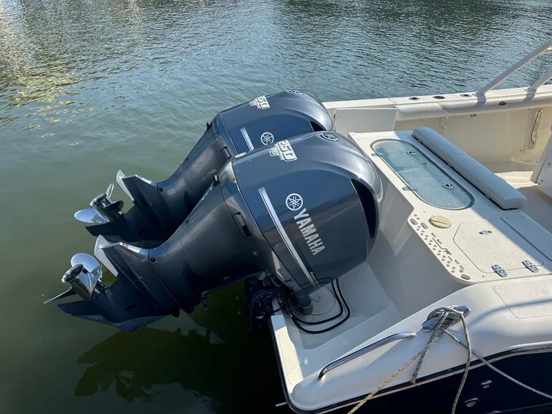 Slide: The Image of 2014 Pursuit S 280 Sport boat with dual Yamaha outboard motors on calm water. - 6