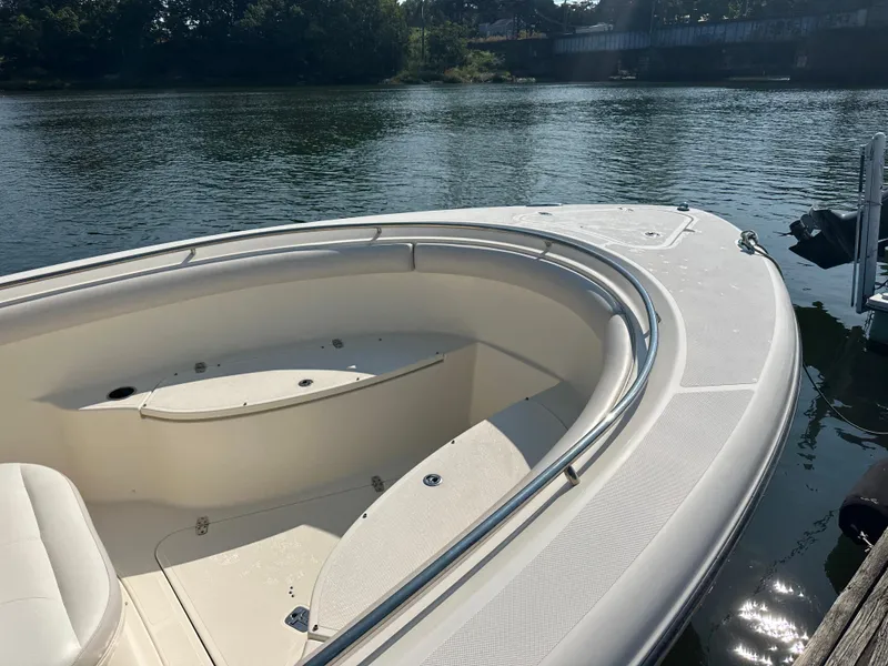 Slide: The Image of 2014 Pursuit S 280 Sport boat on calm water, featuring spacious seating and sleek design. - 9