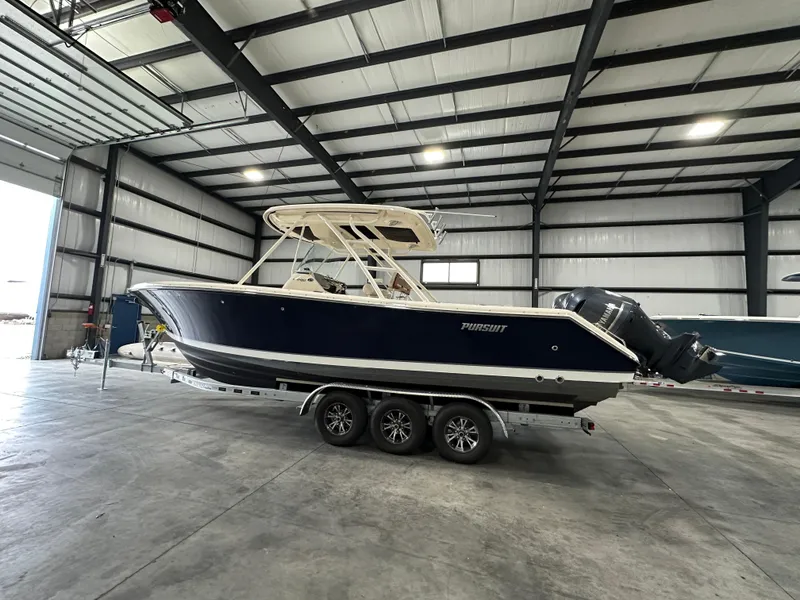 Slide: The Image of 2014 Pursuit S 280 Sport boat in a spacious indoor storage facility. - 13