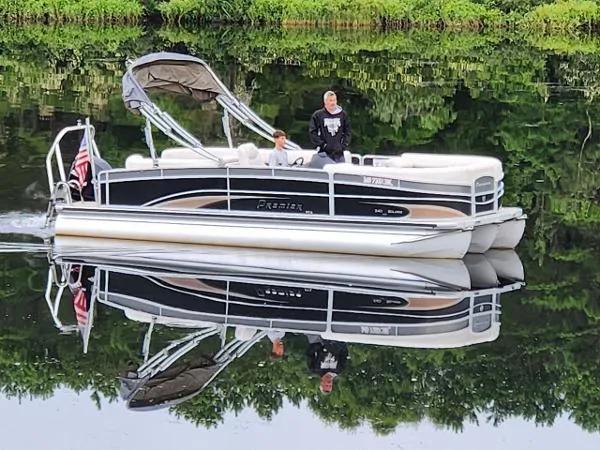 Slide: The Image of Pontoon boat on calm water, Premier Solaris 2012, with lush greenery reflection. - 2