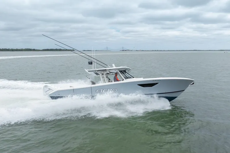 Slide: The Image of 2023 Pursuit S 428 Sport boat speeding on open water. - 12